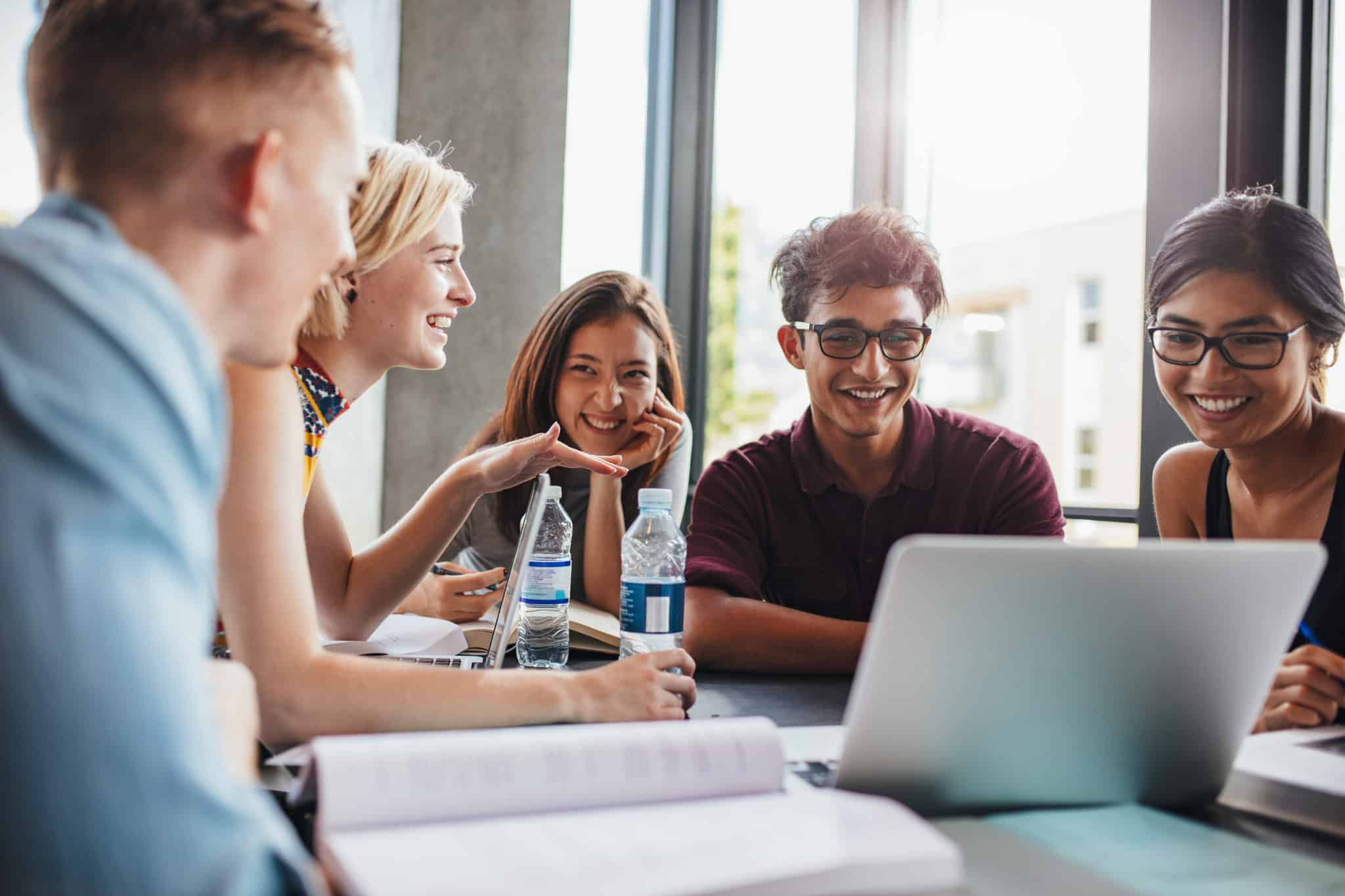 group of people looking at laptop during meeting