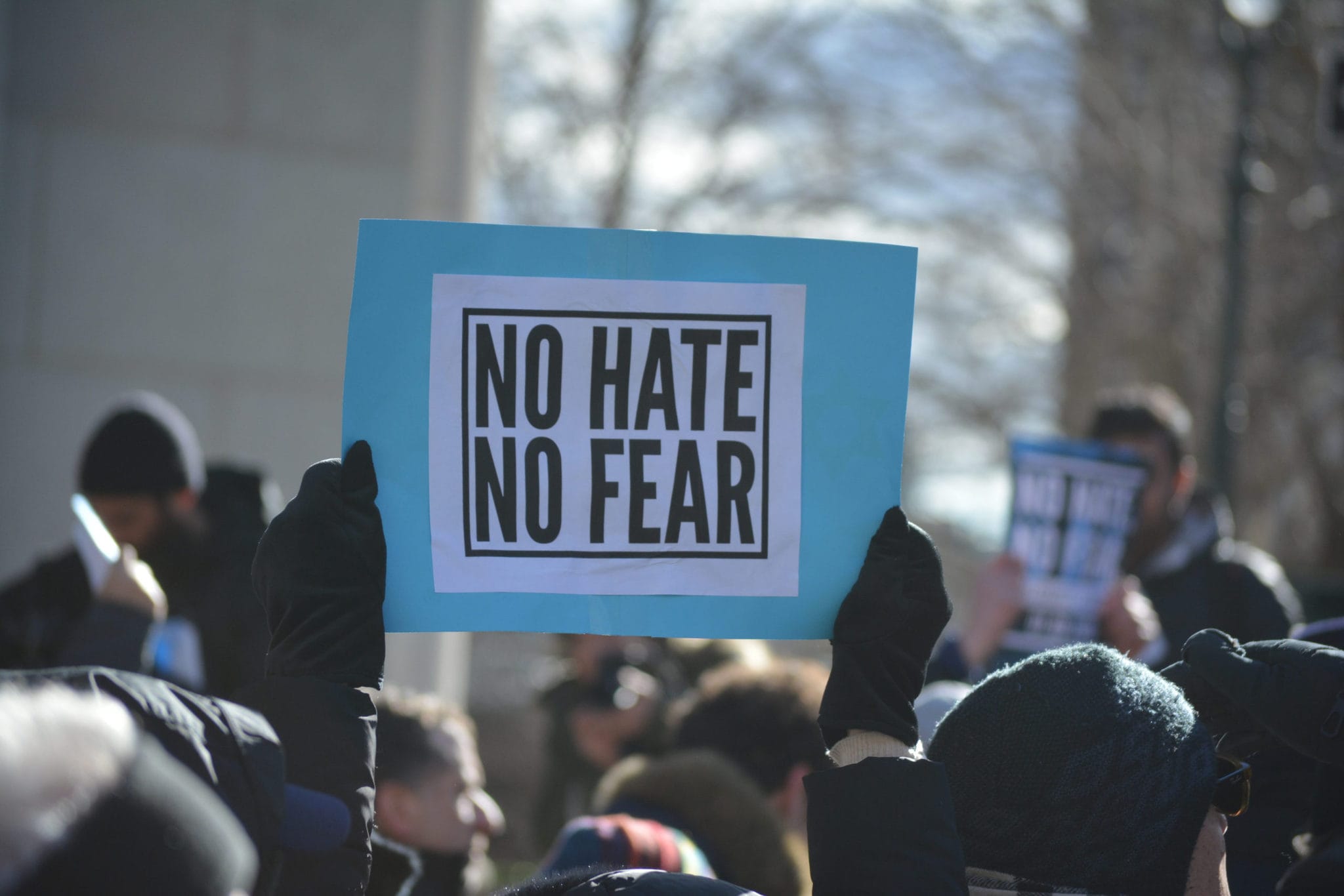 Public march against antisemitism with sign that says no hate, no fear.