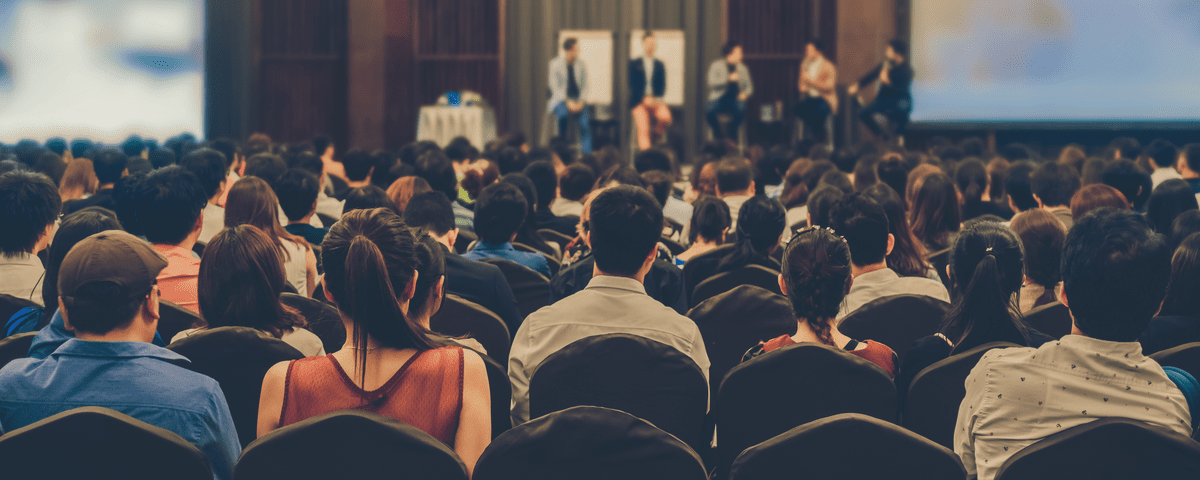 conference meeting with audience and panel speakers