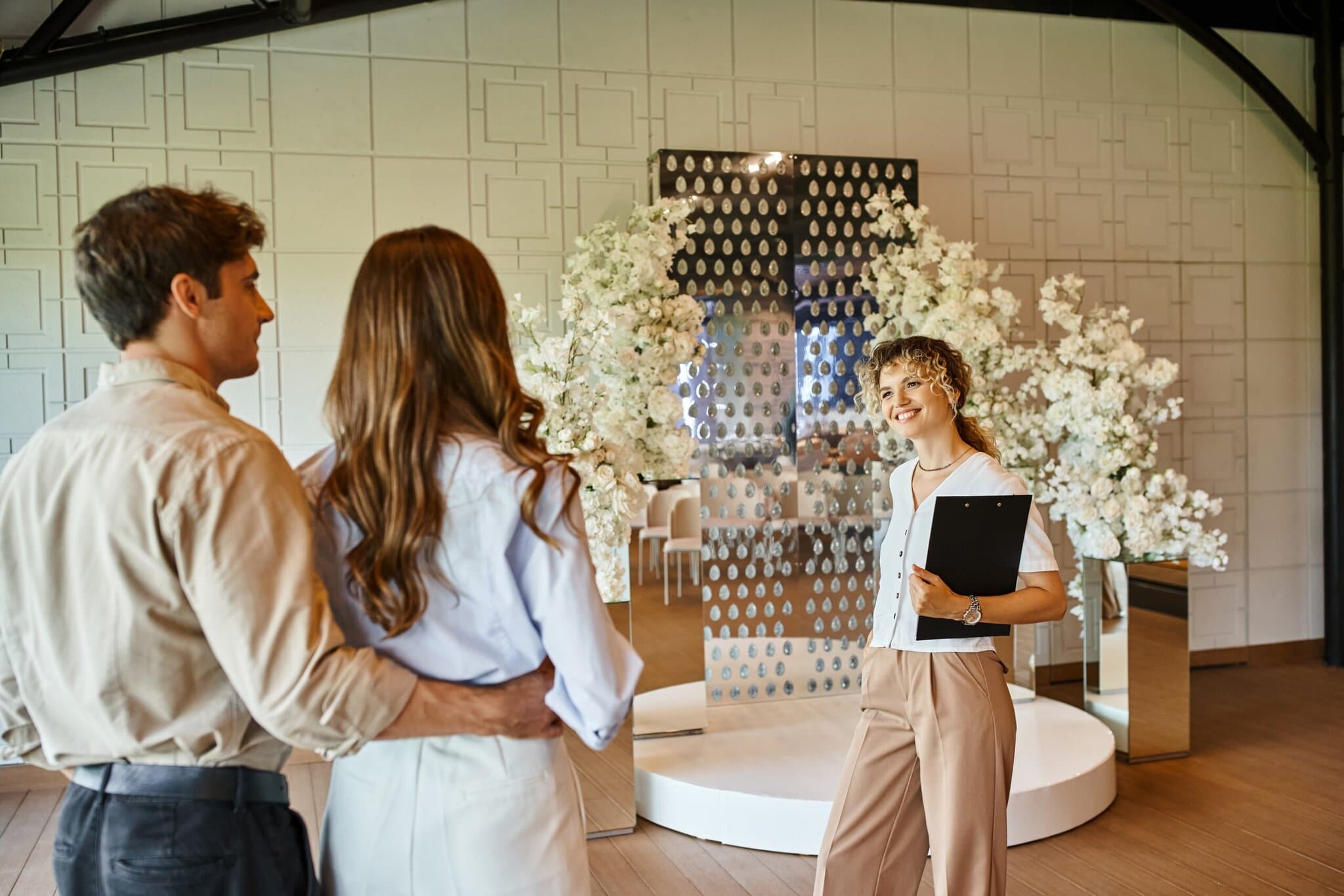 Happy,Event,Manager,With,Clipboard,Showing,Wedding,Venue,With,White