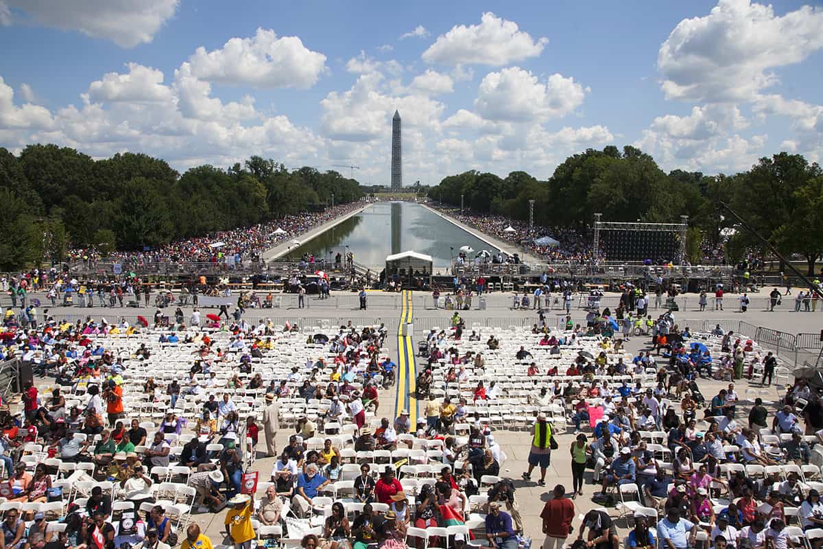 People in seats and in crowd in front of Washington monument