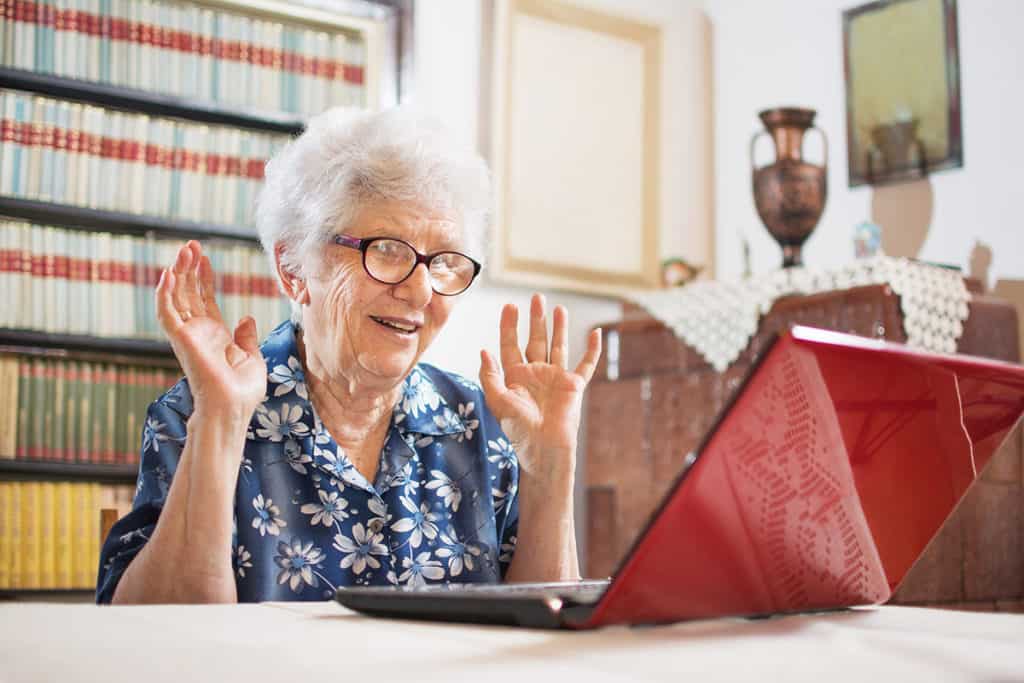 Older woman on video call laptop