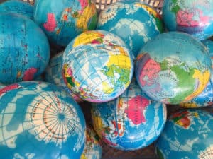 Pile of globes, international partnerships, international fellows
