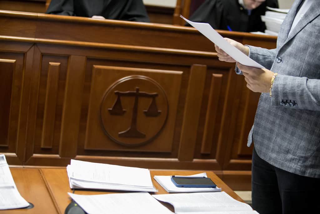 table with papers inside of a courtroom