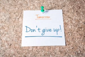 motivation post-it note that says don't give up